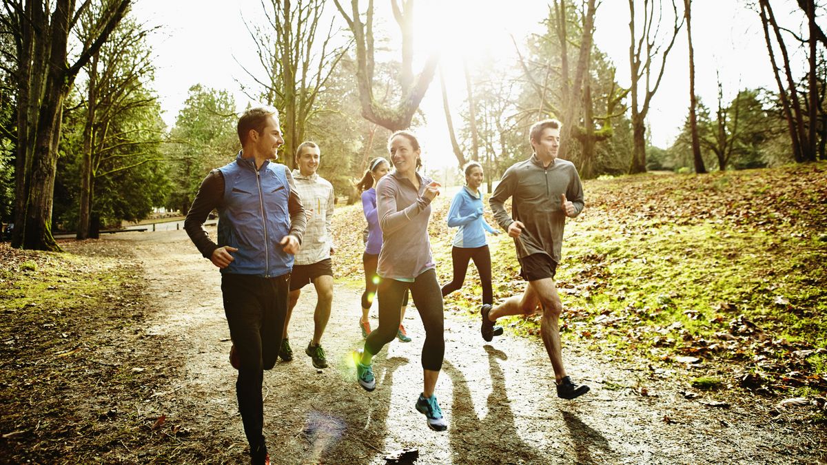 A group of friends running together on a trail