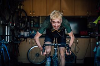 Male cyclist sprinting as hard as he can on the turbo to product his max power in cycling