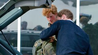 Prince Harry and Prince William packing up car boot with Harry's military backpack