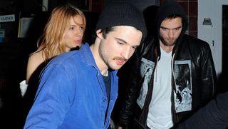 Cap, Jacket, Door, Facial hair, Beanie, Flash photography, Knit cap, Beard, Leather jacket, Display device,