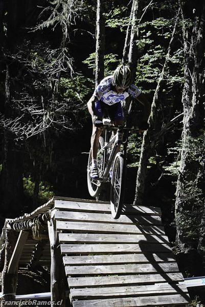 Tinker Juarez rides a bridge on the trails around Nevados de Chillan