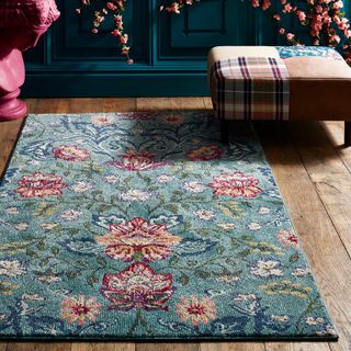 room with floral rug on wooden flooring