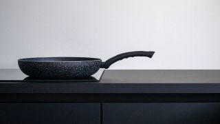 A saucepan sat on an induction hob in a kitchen
