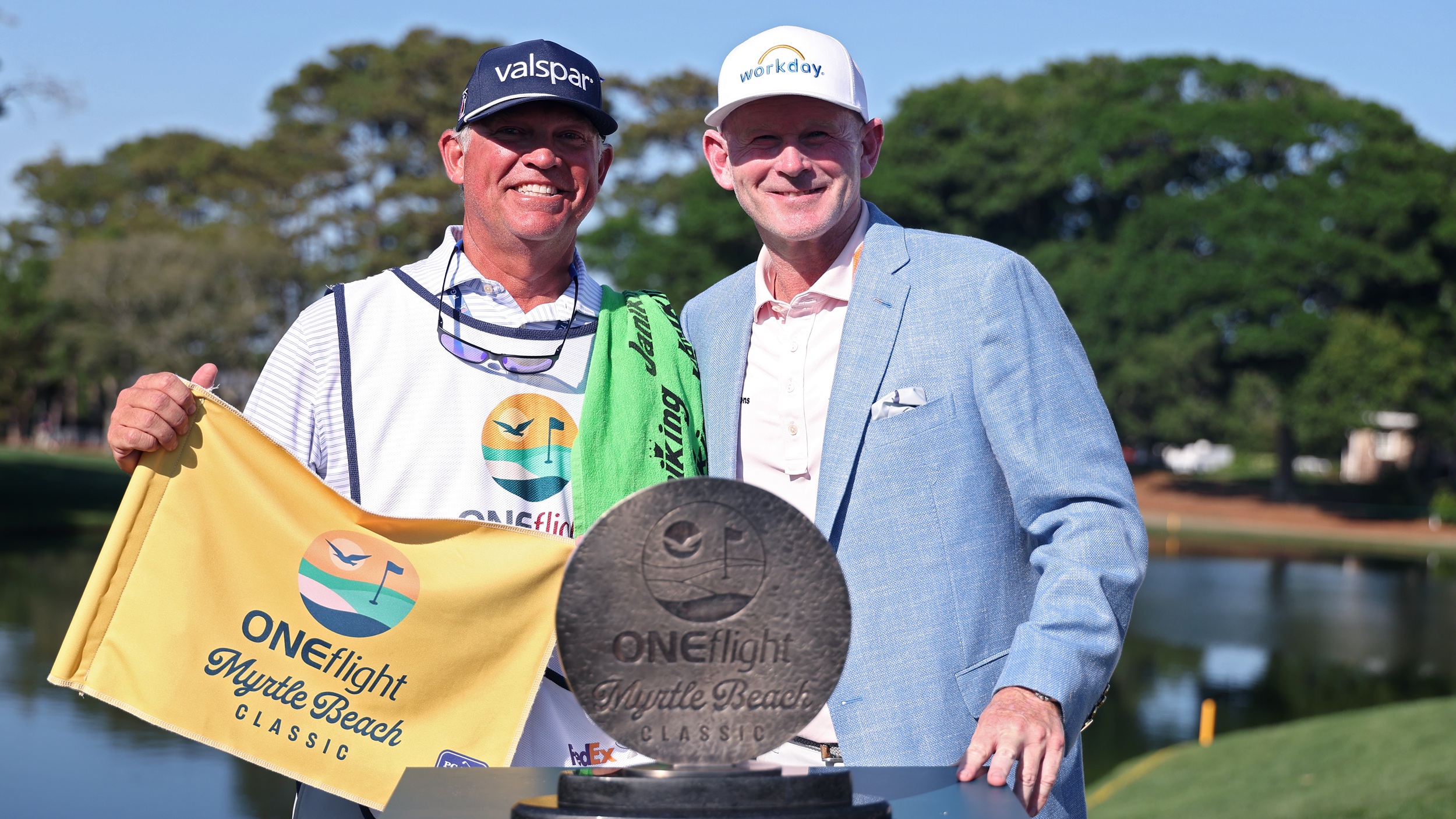 Brandt Snedeker poses with his caddie and the trophy after he won the 2026 Myrtle Beach Classic