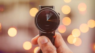 Person holding up a watch