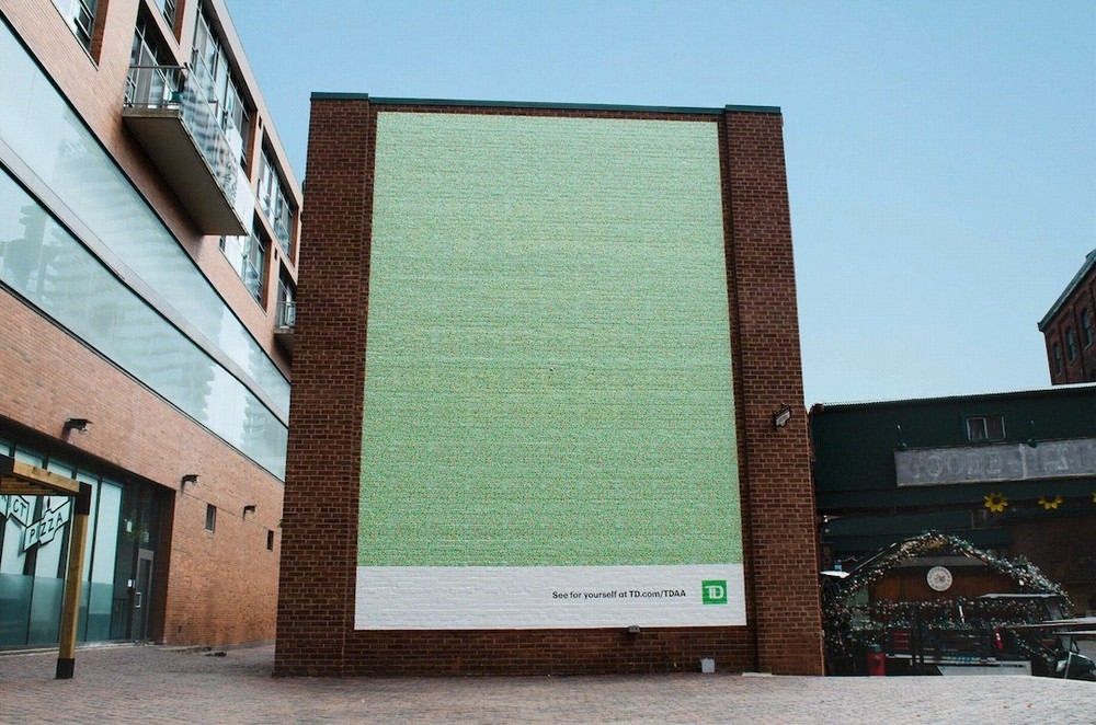 A billboard advert that looks all green but has a secret message that can only be seen by people who are colourblind