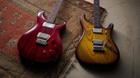 The PRS Fiore HH Satin and SE DGT Standard are pictured together on a rug