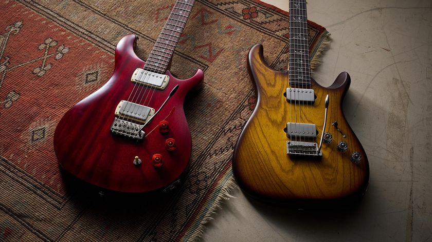 The PRS Fiore HH Satin and SE DGT Standard are pictured together on a rug