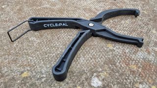 The Cycle Pal tyre seating tool on concrete, unlatched