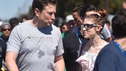 SpaceX founder Elon Musk (L) and Canadian musician Grimes (Claire Boucher) attend the 2018 Space X Hyperloop Pod Competition, in Hawthorne, California on July 22, 2018