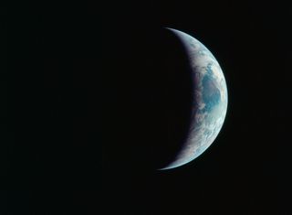 A crescent Earth hangs in the black of space in this amazing photo captured by Apollo 11 astronauts during NASA's historic first manned moon landing between July 16 and 24 in 1969.