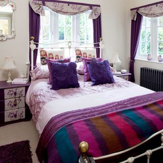 bedroom with purple curtains and beddings