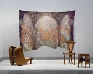 Hanging tapestry and wood furniture