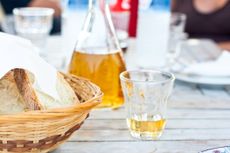 a glass of retsina on a table