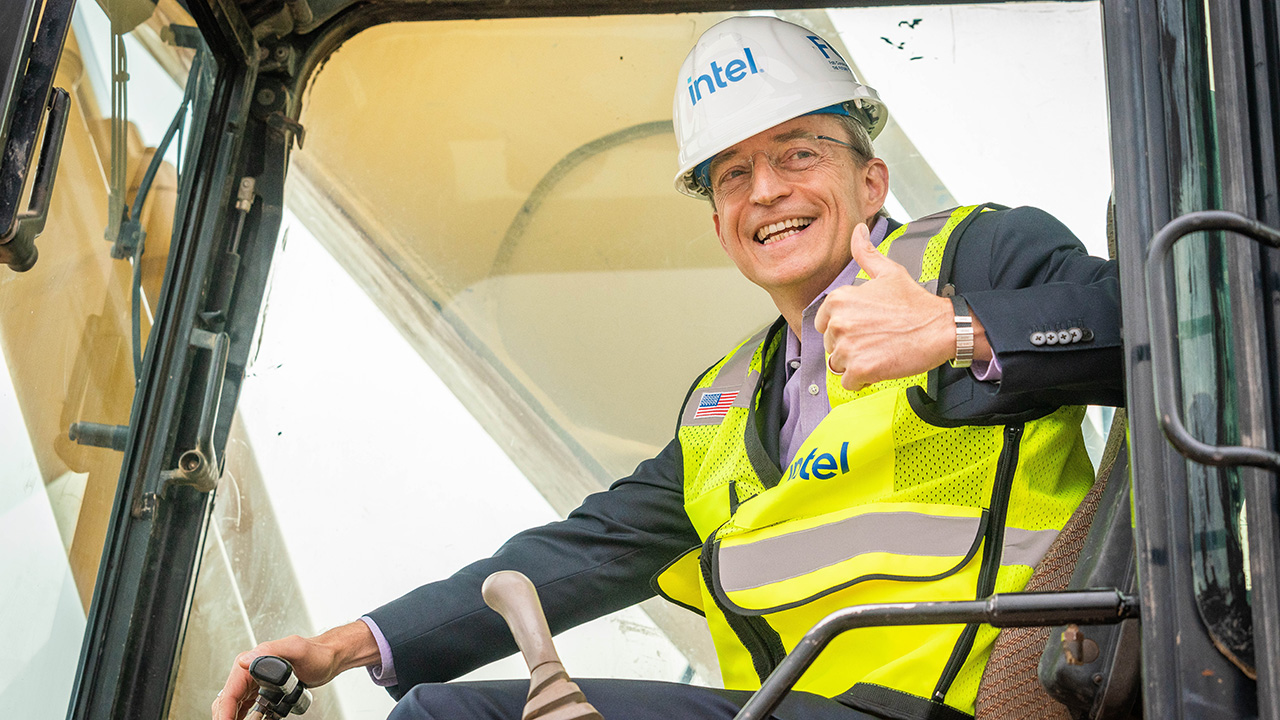 Intel CEO Pat Gelsinger signals to the crowd from earth-moving equipment in Chandler, Arizona, on Friday, Sept. 24, 2021