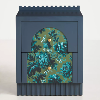 A navy nightstand with floral detail