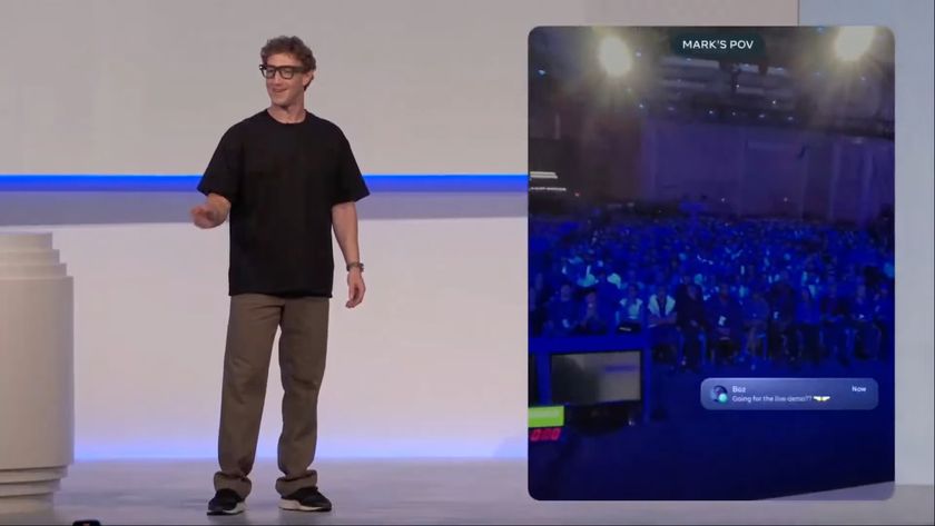 Mark Zuckerberg standing onstage at the Meta Connect 2025 livestream event, wearing a pair of Ray-Ban Meta glasses and attempting to answer a call