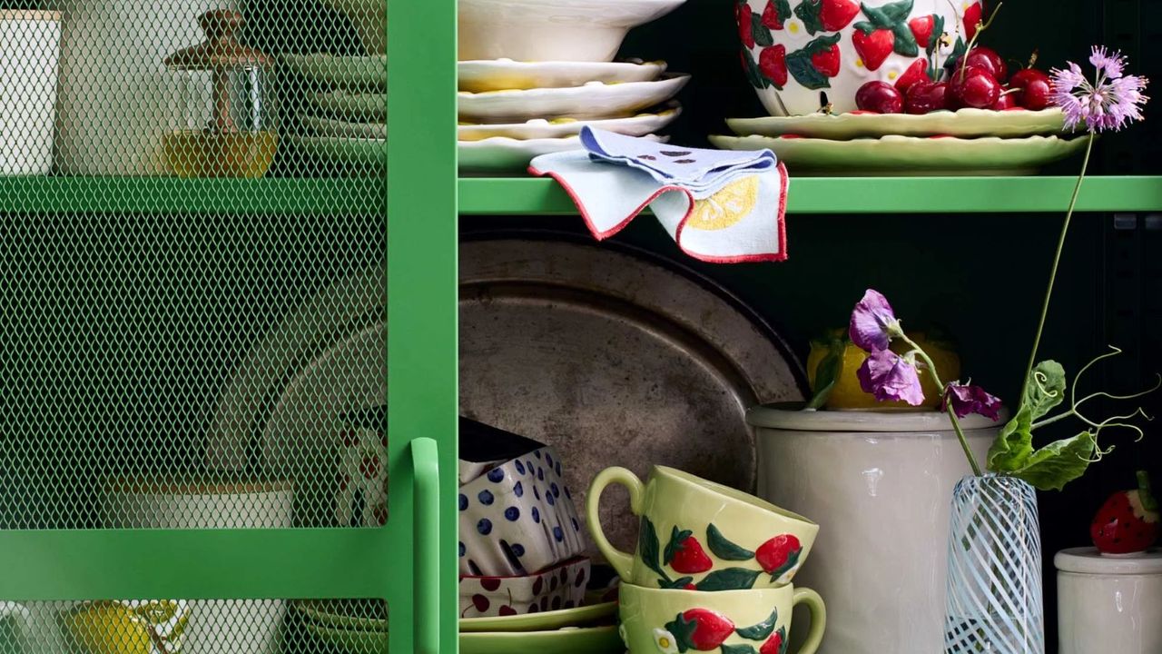 spring kitchen cupboard filled with pretty crockery flowers and fruit