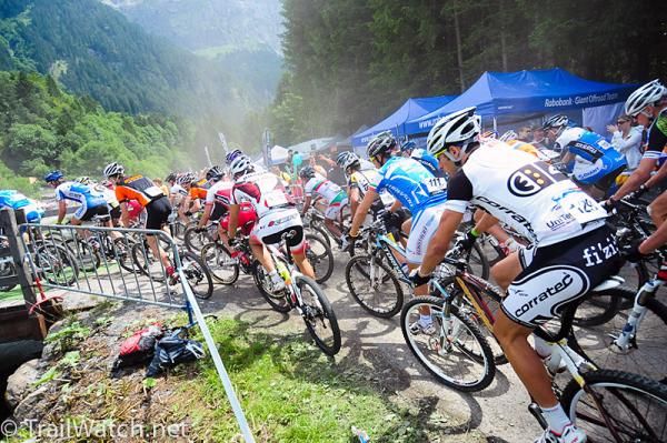 Elite men speed into the steep Alps.
