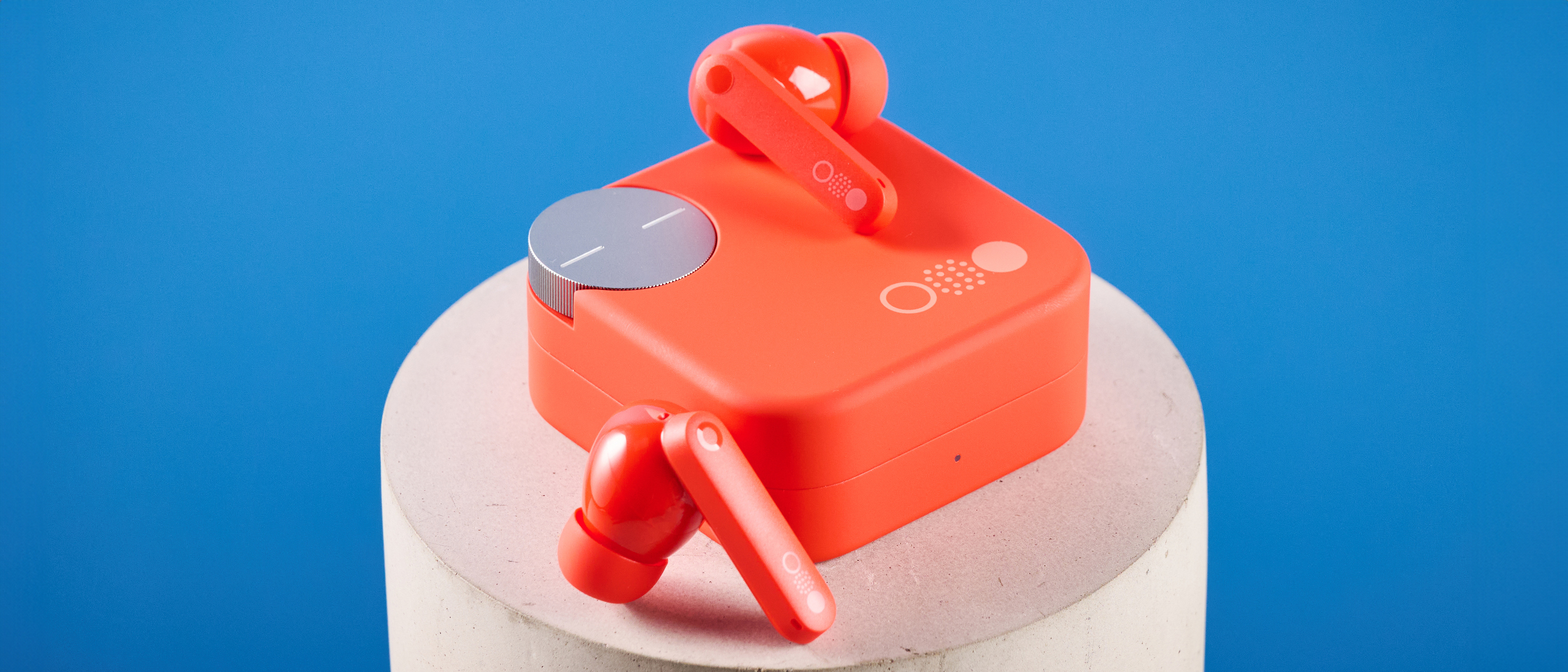 the nothing cmf buds pro 2 cmf by nothing buds pro 2 in bright orange shown in the smart dial charging case against a blue tom&#039;s guide background