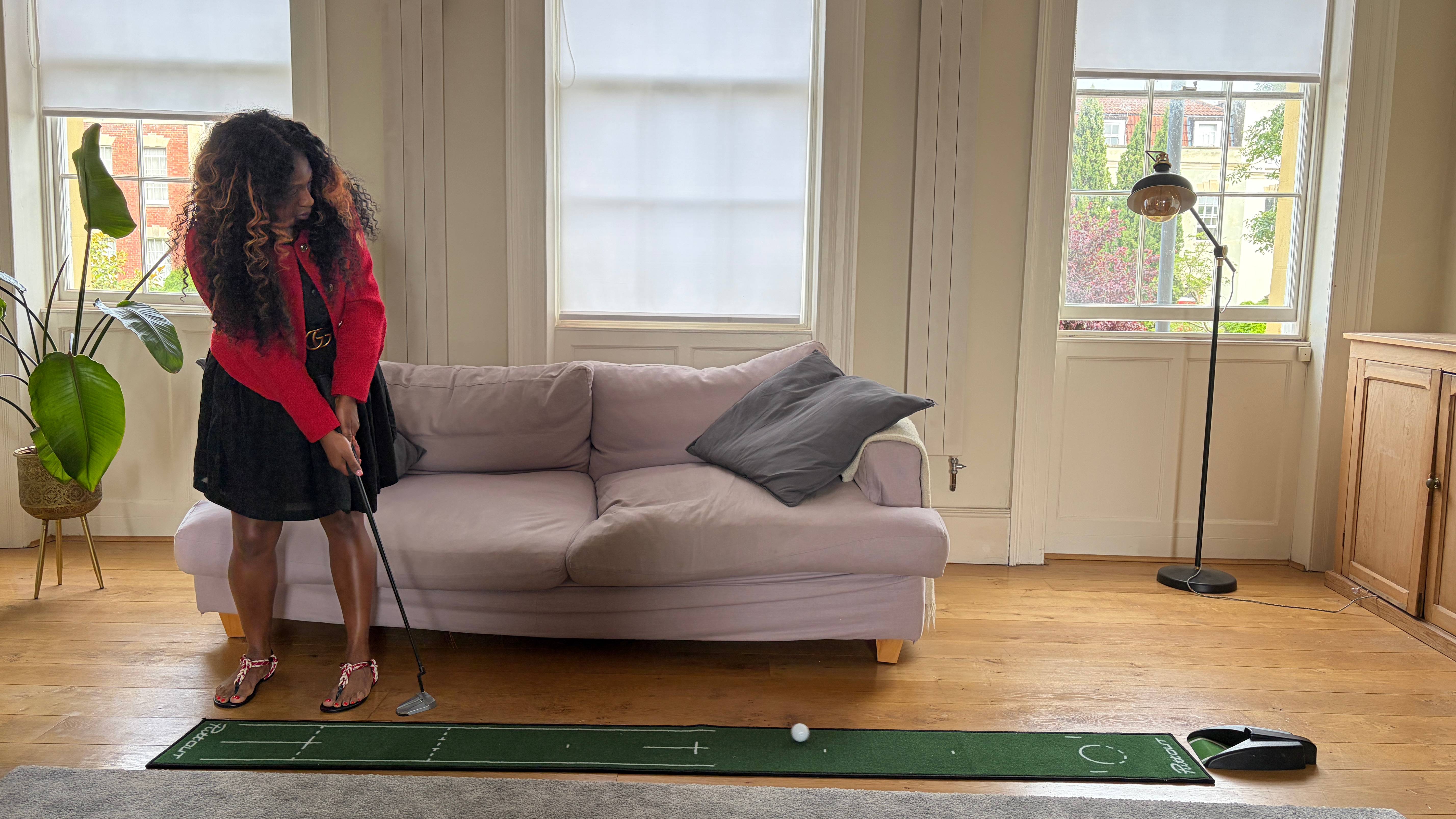Genelle Aldred using a putting mat at home
