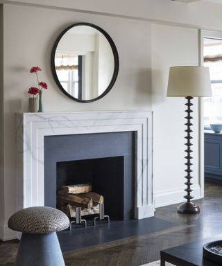 Detail of a living room with large Art Deco-inspired marble fireplace