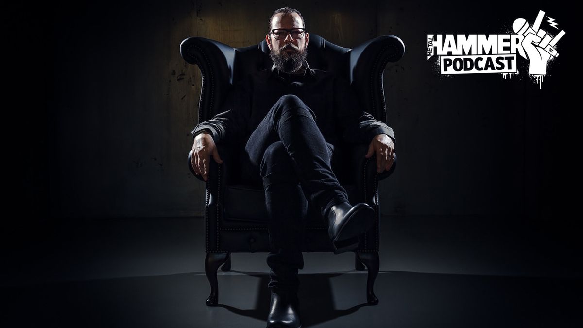 Ihsahn sitting on a chair in darkness