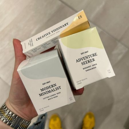 Junior beauty editor Grace Lindsay holding three H&M perfumes