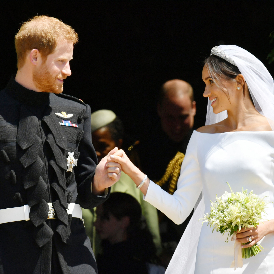 Prince Harry wears military uniform and Meghan Markle wears a white wedding dress by Givenchy at their royal wedding on May 19, 2018