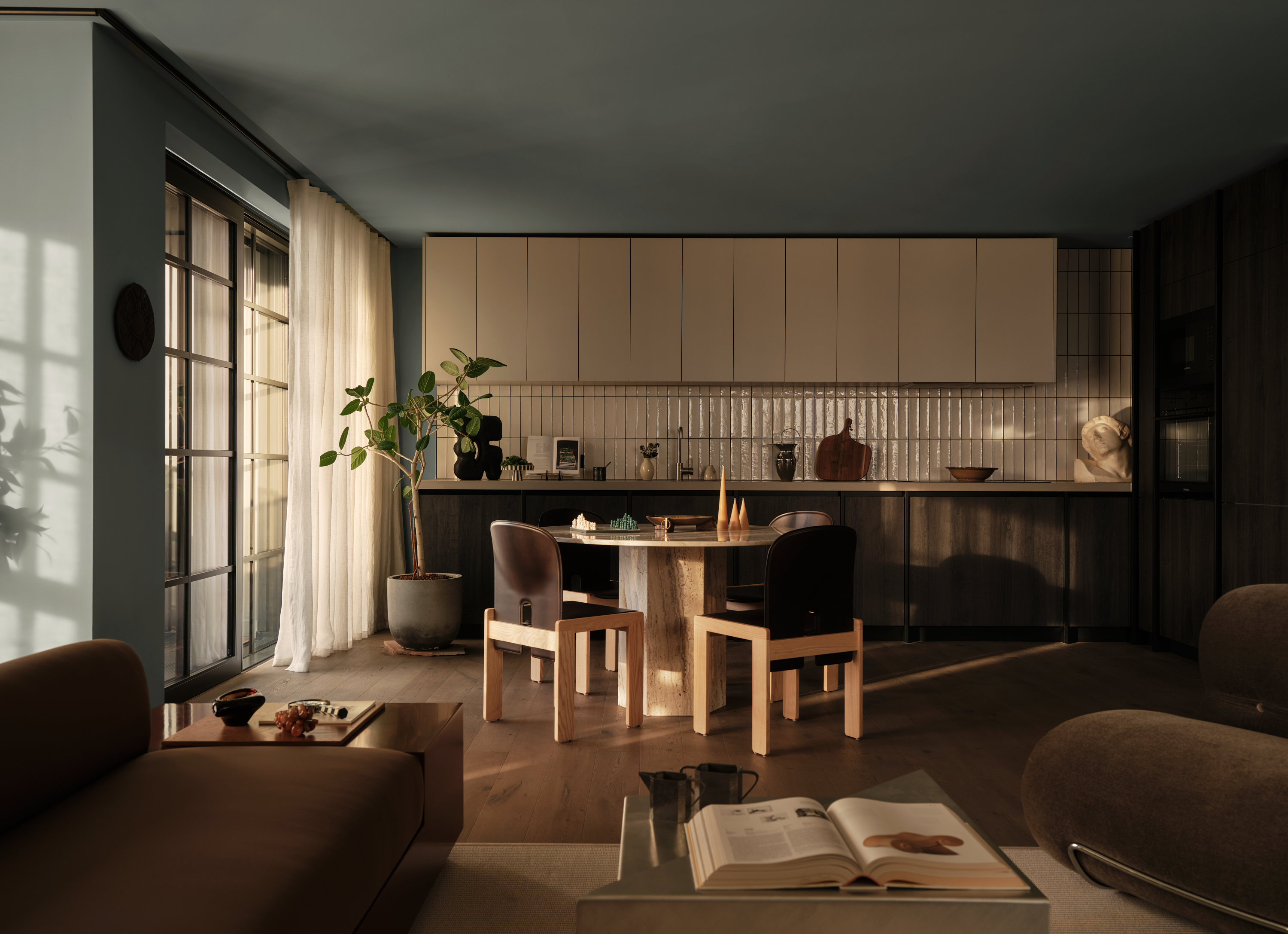 view of the Penthouse at The Founding by Conran and Partners, including timber based furniture and warm colours under moody lighting