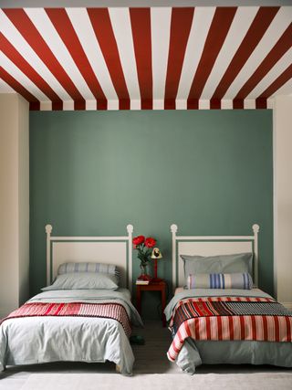 green twin bedroom with red and white painted ceiling