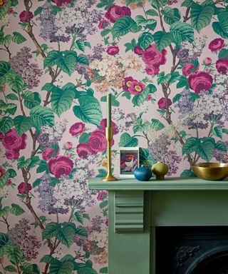 Pink and green floral wallpaper, green painted fireplace, decorated with ornaments
