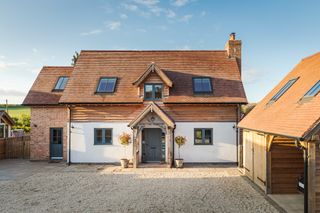 oak frame exterior with gravel driveway