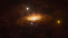 An artist's impression of a supermassive black hole, wreathed in orange gas, waking up from a long slumber