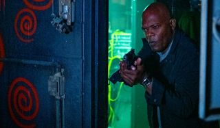 Samuel L. Jackson investigates a room, gun drawn, in Spiral: From the Book of Saw.