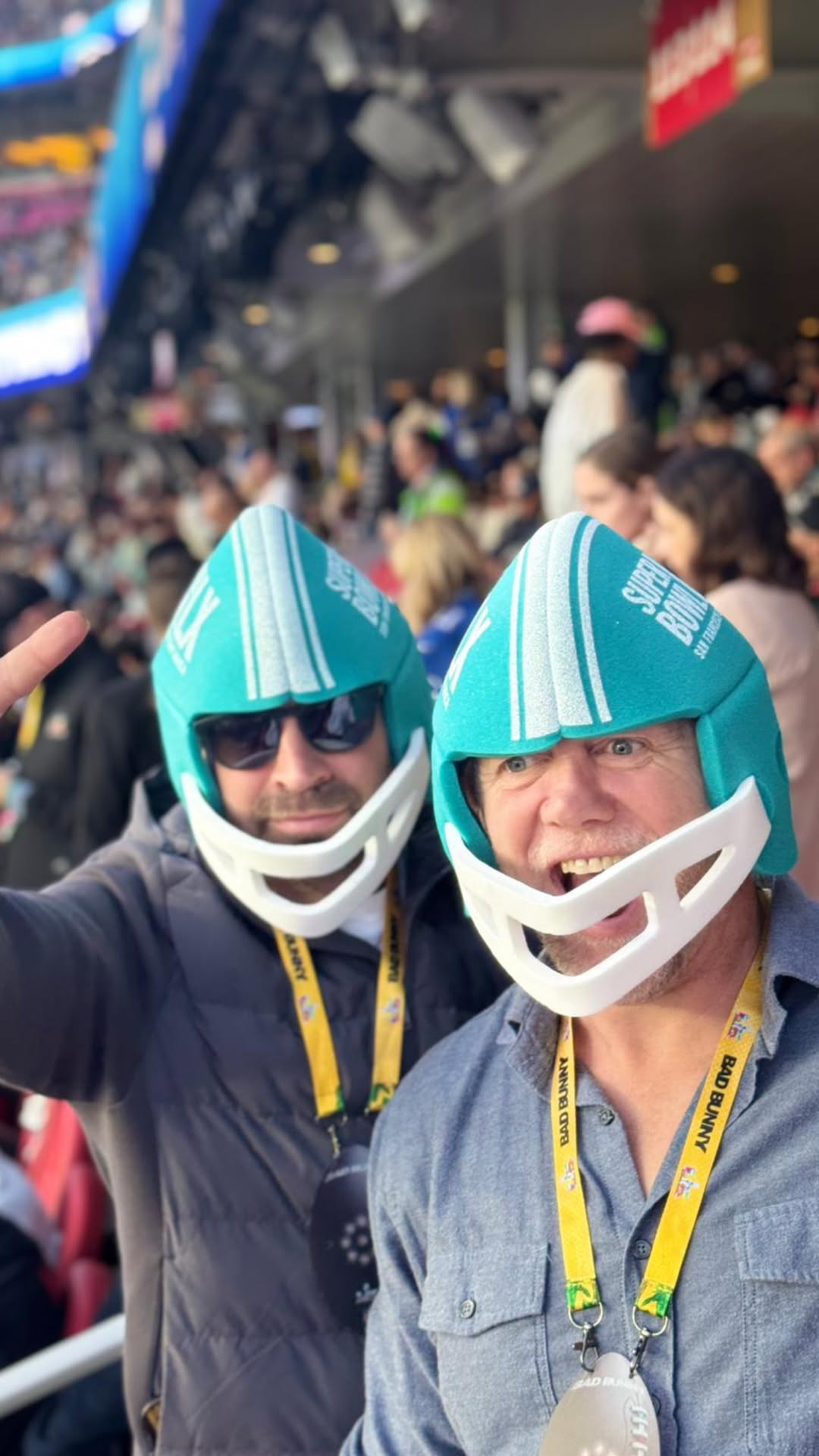 Mike Tindall wearing a blue helmet and cheering with a friend at the Super Bowl