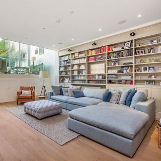 living room with l shaped sofa and wooden flooring