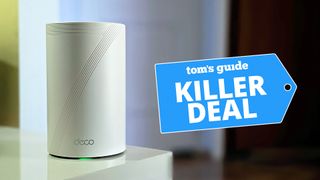 TP-Link Deco BE11000 (BE65) Tri-Band router on corner of table with Killer Deal badge overlaid