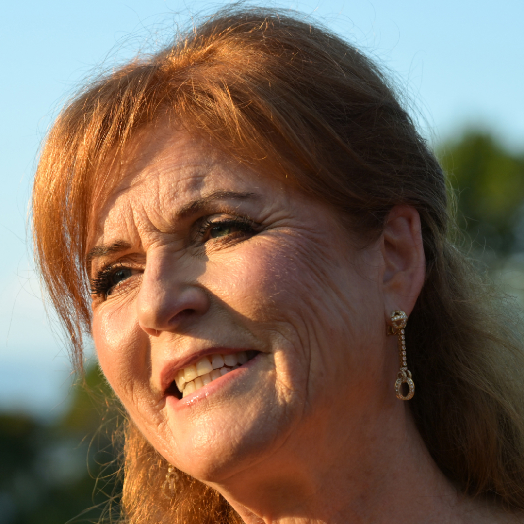A headshot of Sarah Ferguson smiling in front of some trees