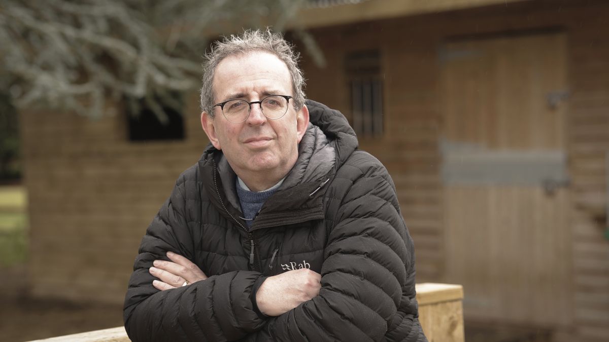 Reverend Richard Coles in a black coat with his arms folded in Good Grief? with Reverend Richard Coles