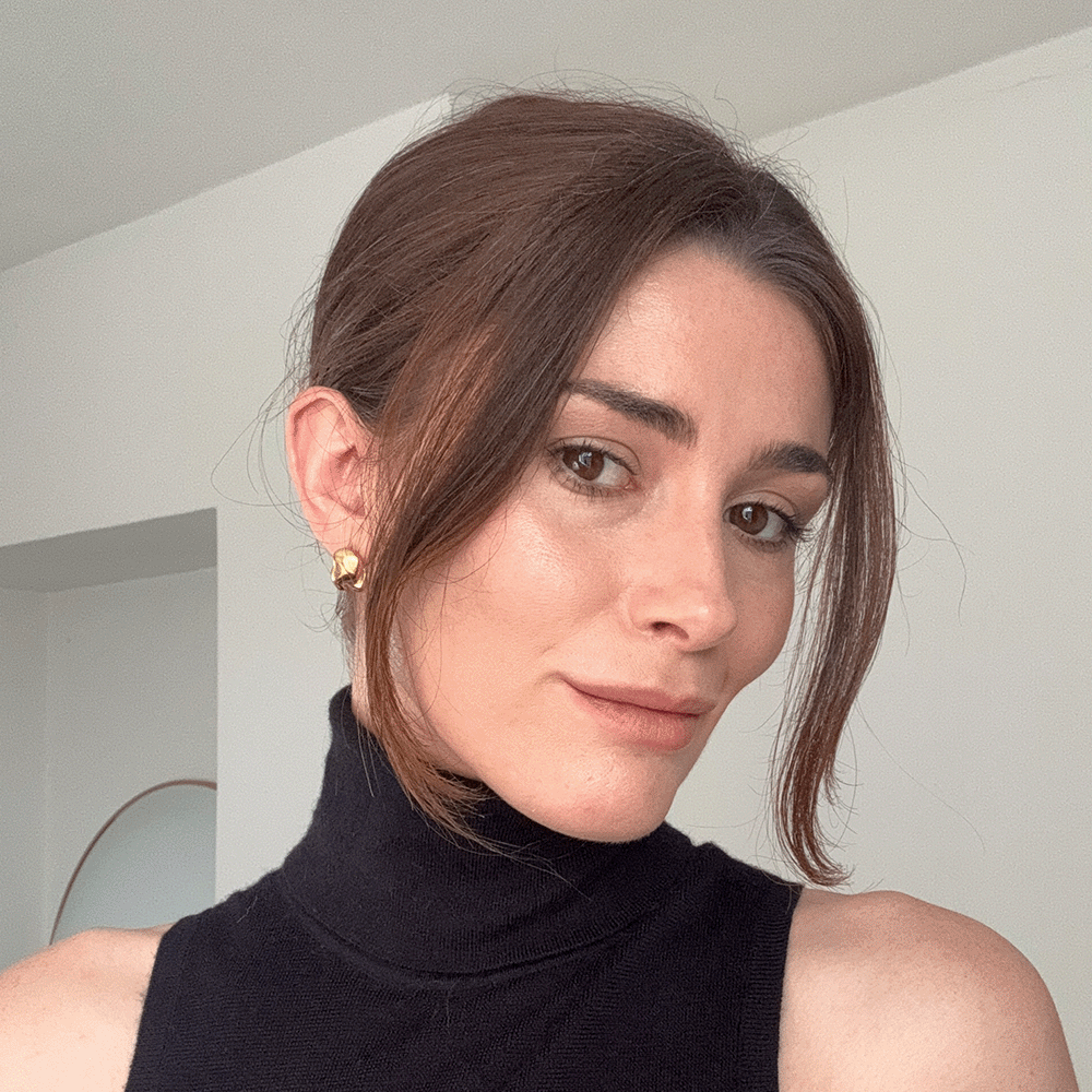 A gif of Eleanor wearing a French pin in a French twist hairstyle