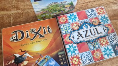 A photograph of three board games on a table