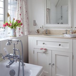 bathroom with bathtub and white cupboard