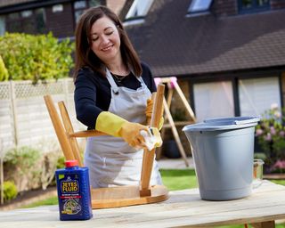 melanie lissack using a cloth to rub jeyes fluid into chair legs - jeyes fluid