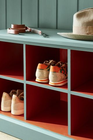 painted wooden shoe storage unit with coloured interior in orange