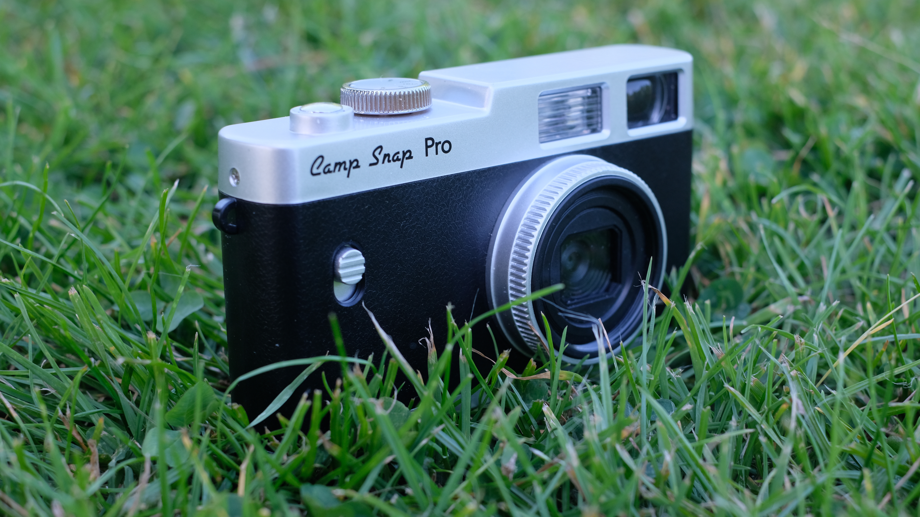 Photograph of Camp Snap CS-Pro digital compact camera standing upright in grass