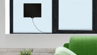 The Mohu Leaf in a living room near a TV.