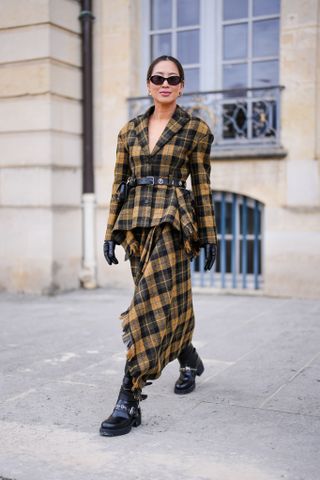 Woman in plaid jacket and skirt