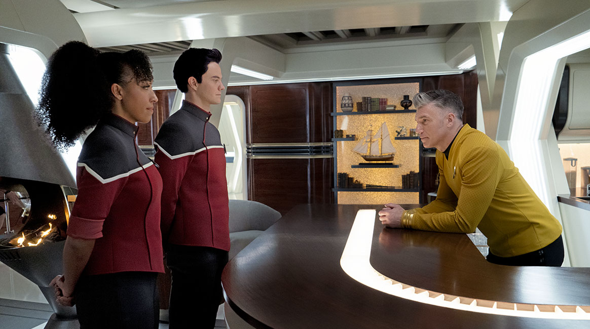 three characters in starfleet uniforms on a spaceship