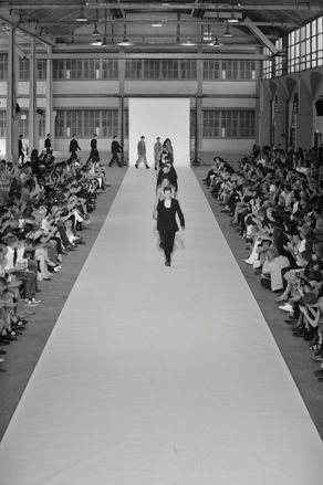 Models in single file on runway